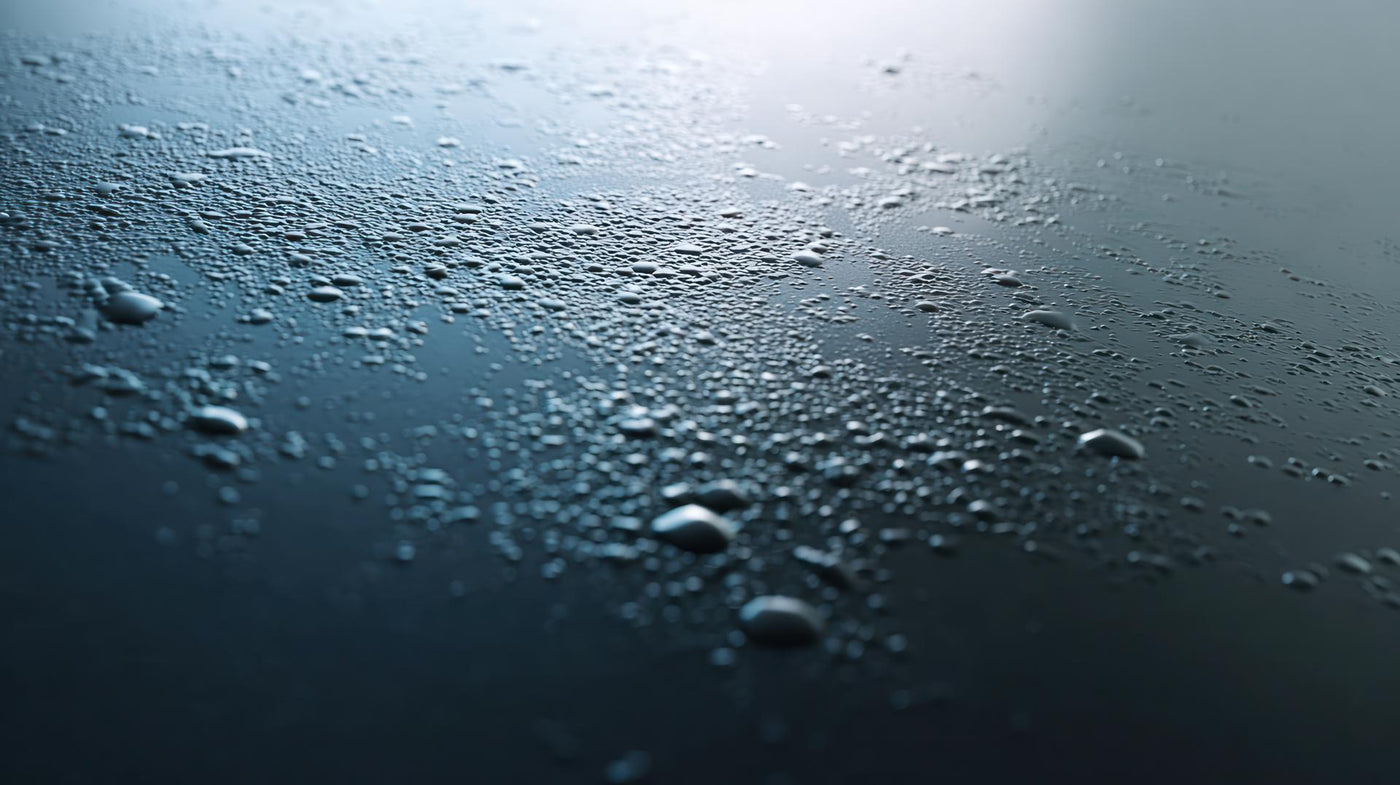 Close up of water droplets forming on a smooth surface abstract texture