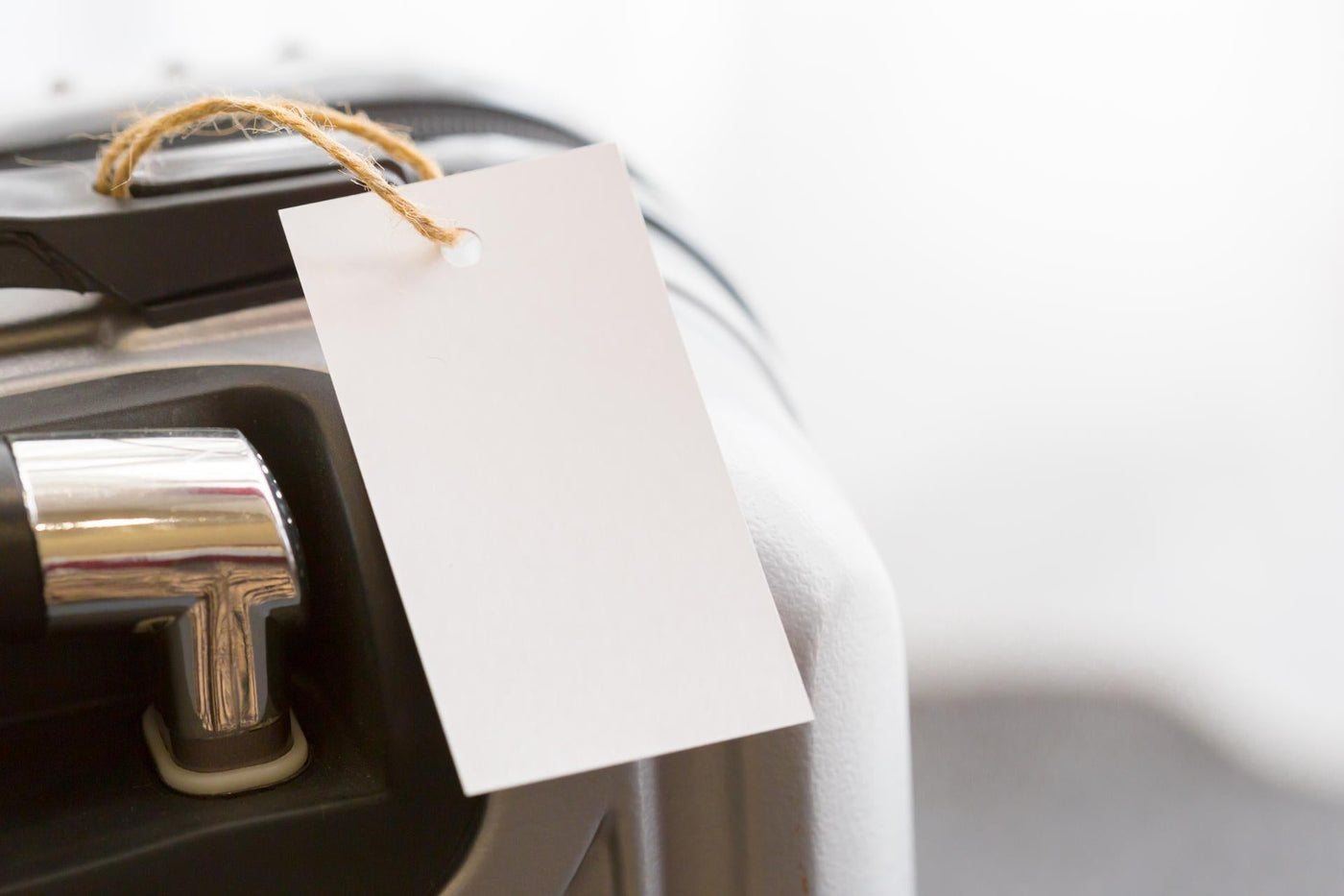 Luggage with blank tag ready for travel at an airport check-in area