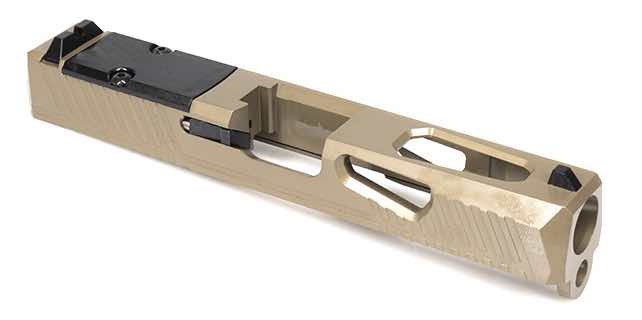 A tan-colored firearm slide with cutouts and a black component.