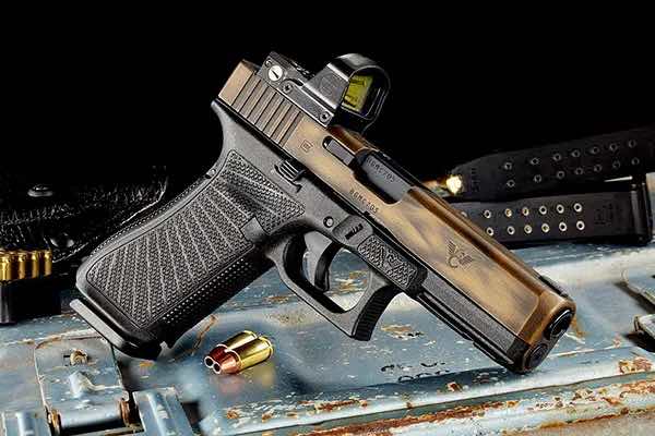 A pistol resting on a textured surface with ammunition nearby.