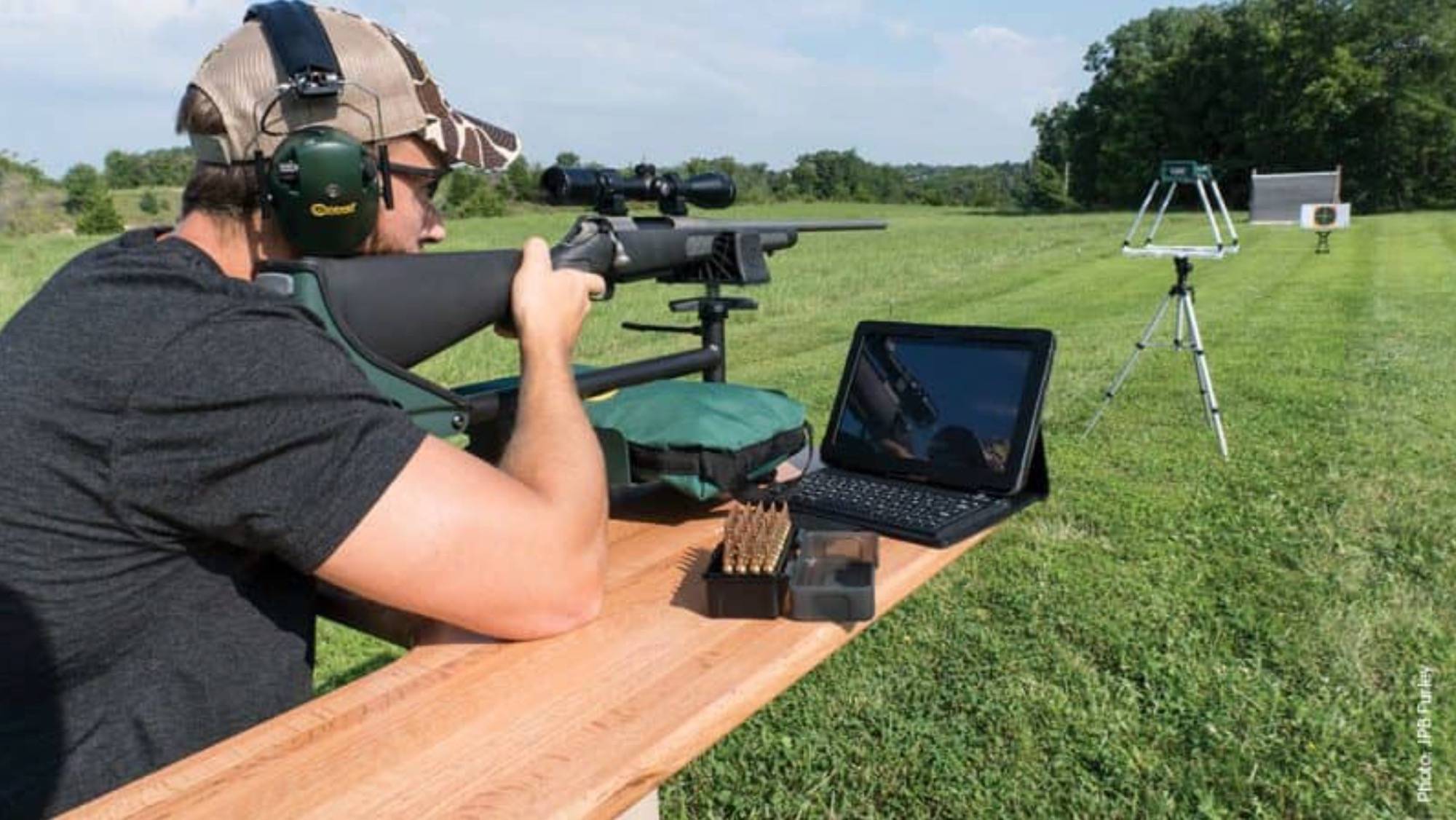 Man Shooting Rifle Through Chronograph