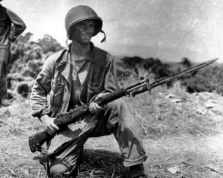 Military man holding a M1 Garand
