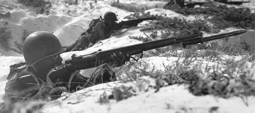 Soldier in foxhole with M1 Garand rifle