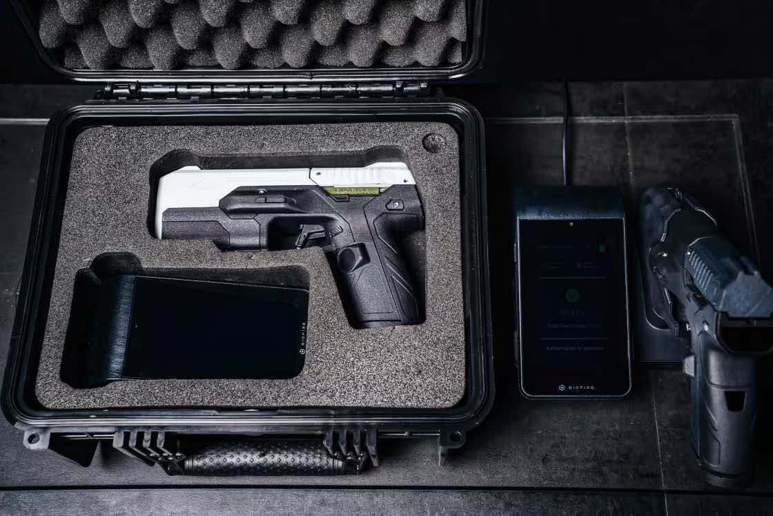 A handgun and accessories in a protective case on a surface.