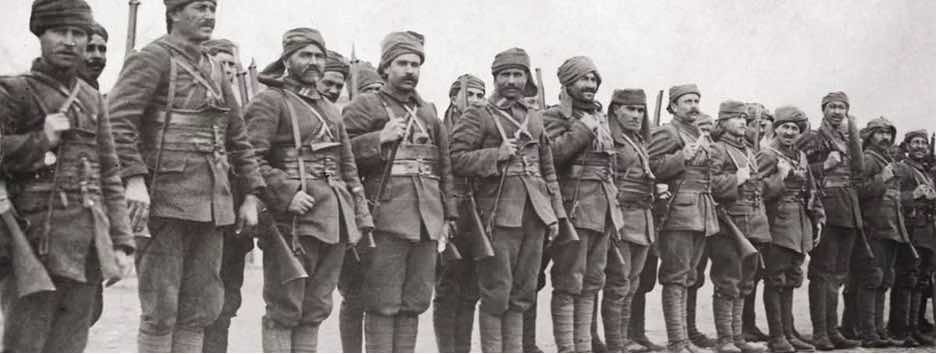 A line of soldiers in military uniforms standing together.