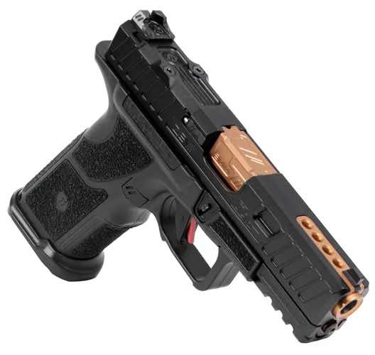 Black and orange ZEV TECHNOLOGIES O.Z-9 semi-automatic pistol on a white background.