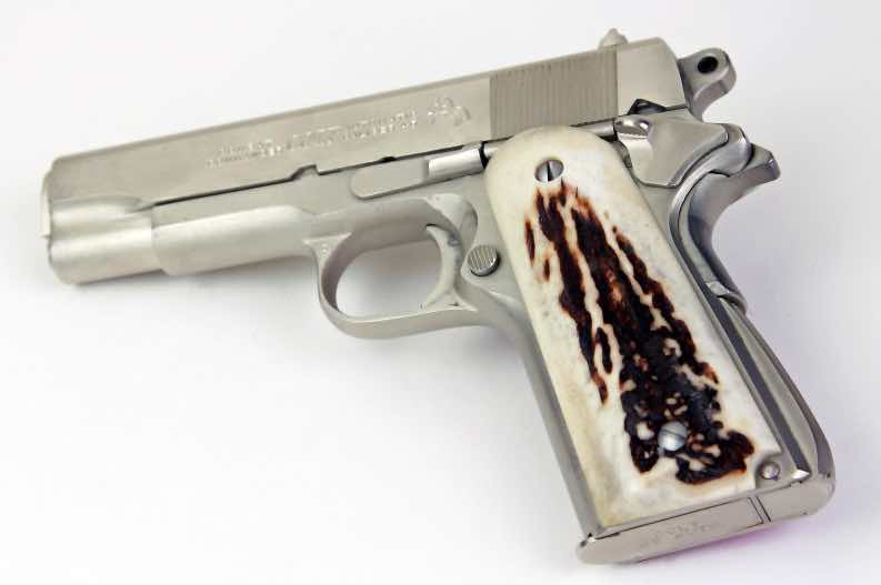 A silver handgun with a decorative grip.
