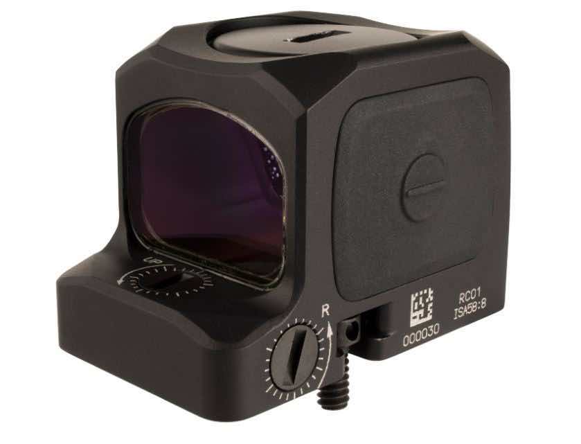 Black optical sight with purple lens and adjustment knob.
