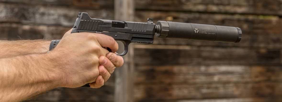 Man Shooting 9mm With Silencer Attached