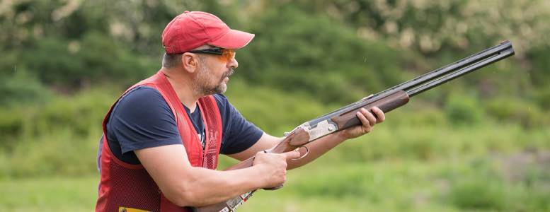 Man Getting Ready to Shoot Skeet With a Shotgun