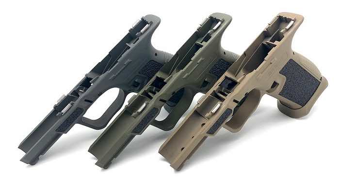 Three handguns in different colors arranged side by side.