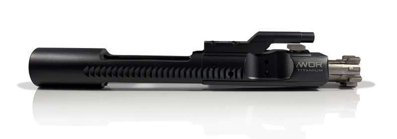 Black firearm bolt carrier group on a reflective surface.