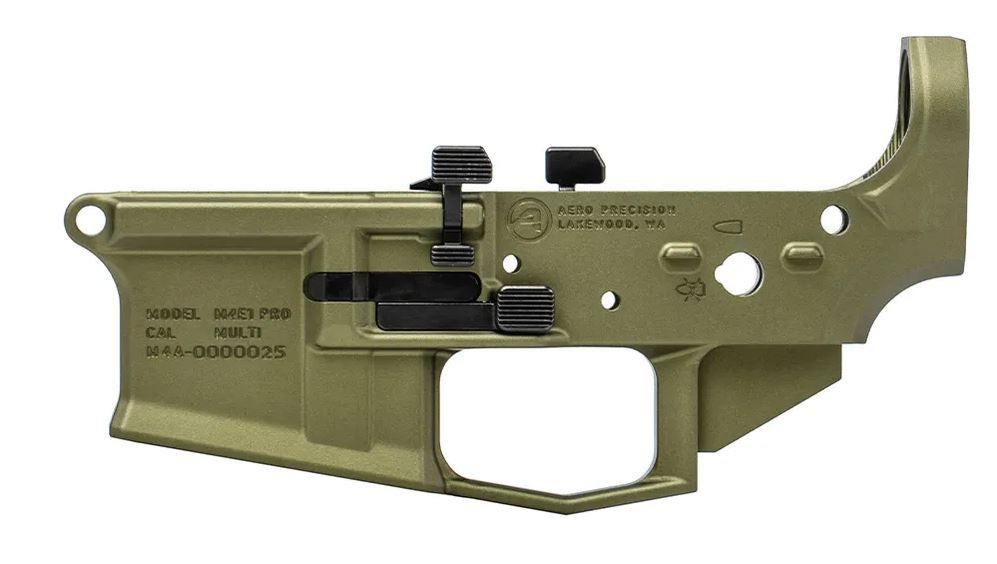 Olive green firearm lower receiver with various components attached.