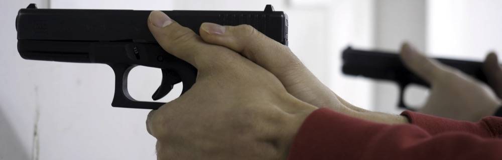 Man shooting handgun at range