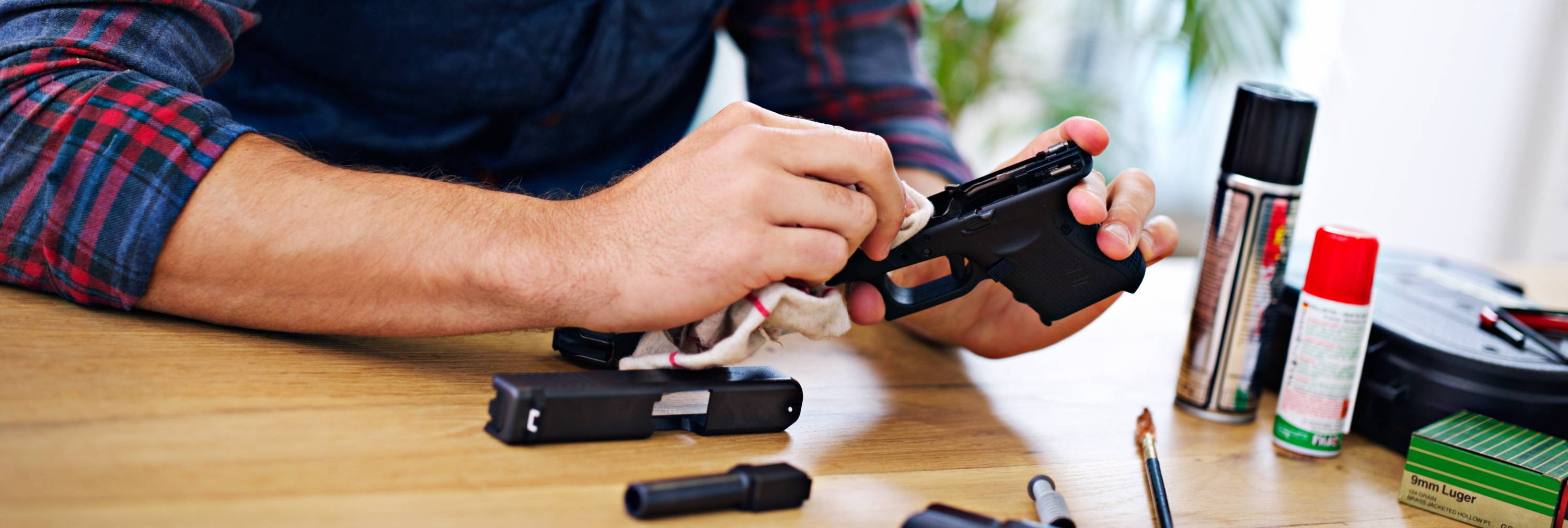 Man Cleaning 9mm With Gun Oil