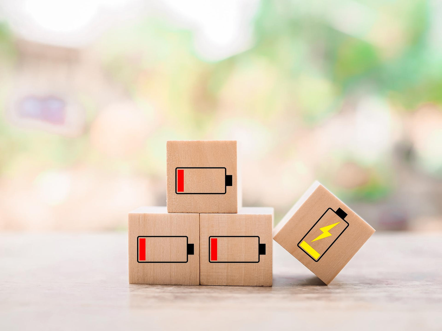 Wooden blocks with status of battery icons.