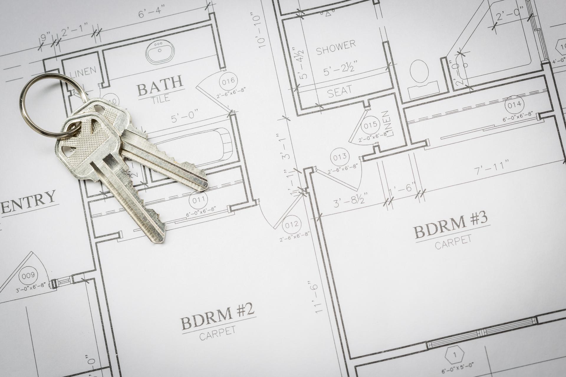 Set Of New House Keys Resting On House Plans