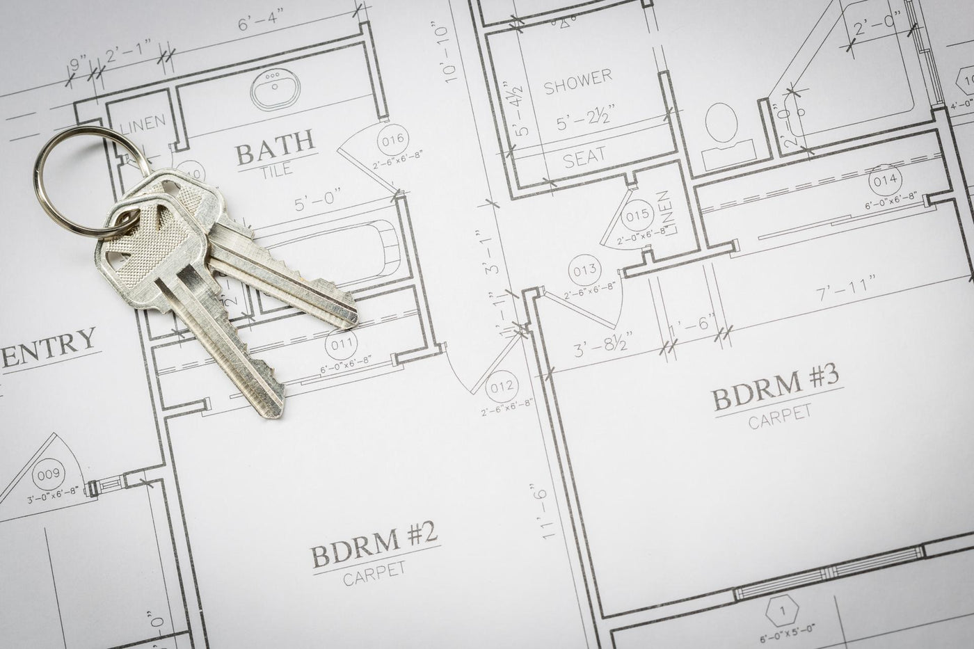 Set Of New House Keys Resting On House Plans