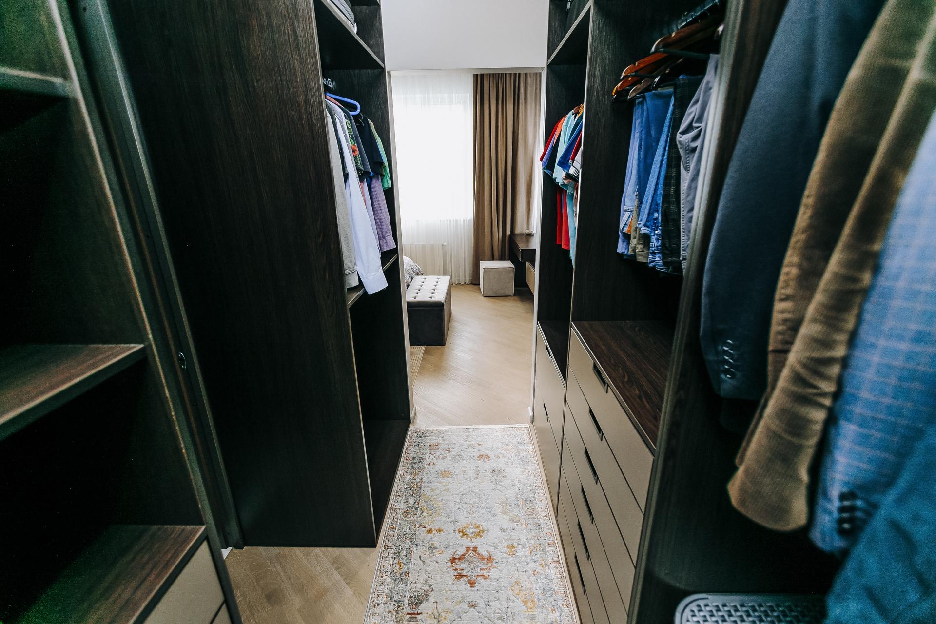 Stylish WalkIn Closet featuring Organized Clothing with a Modern and Elegant Design