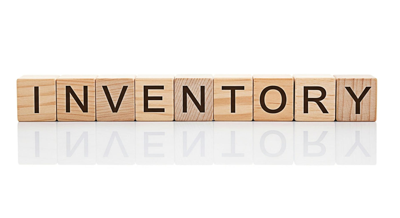 Wooden blocks spelling INVENTORY on a white reflective surface representing stock management and control conveying a sense of organization and order in business and supply chain operations
