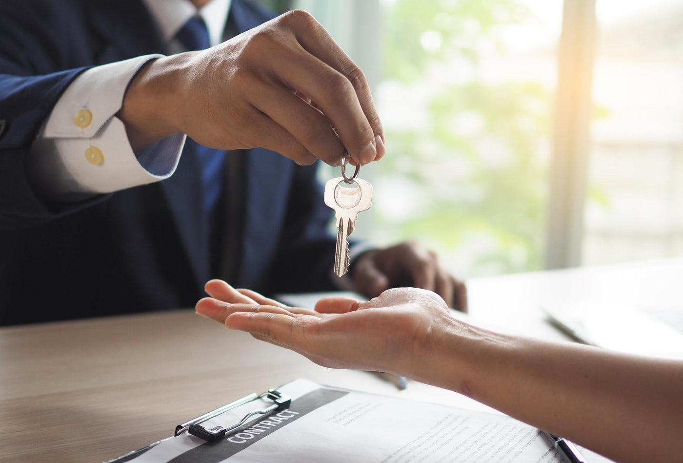 House salesmen are sending keys to new homeowners.  Buying, selling, renting, changing homes