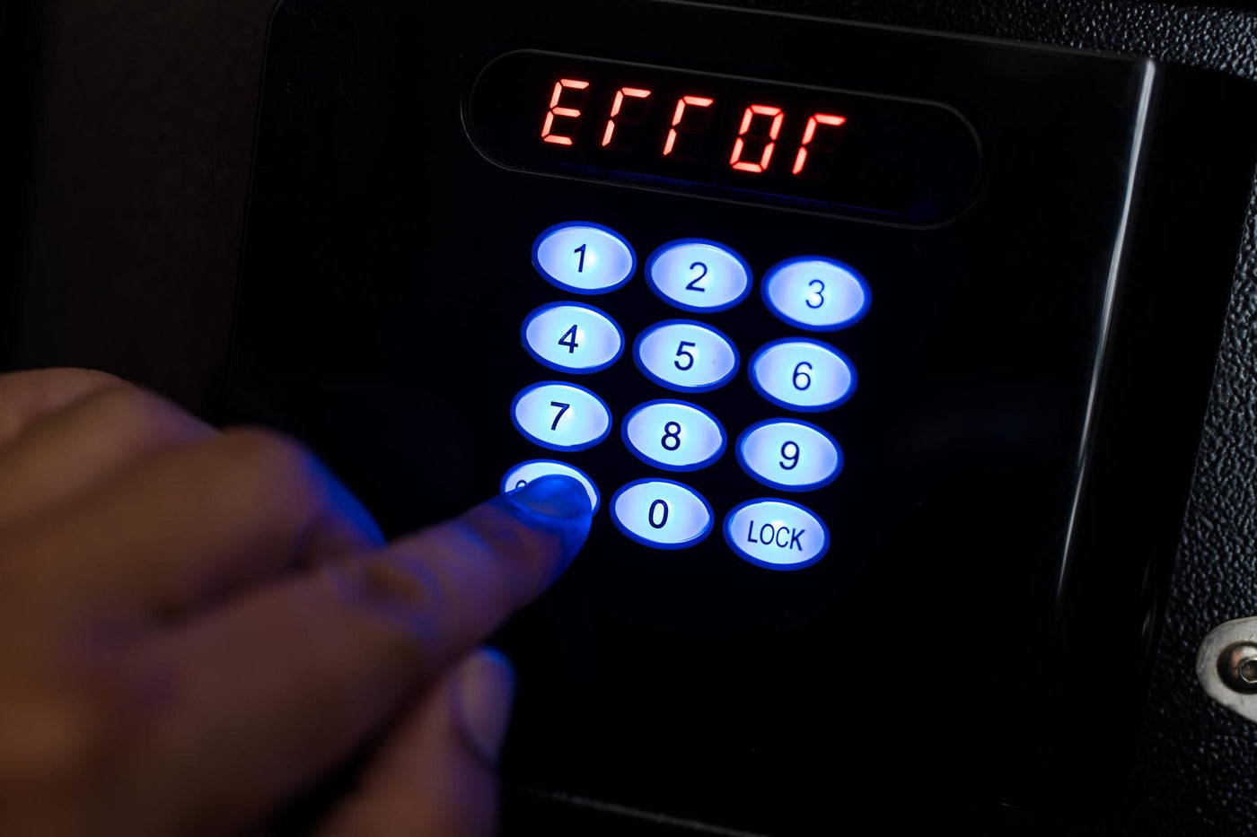 Man trying to press passwords on safety lock pad for open a safety box and wrong a PIN code.