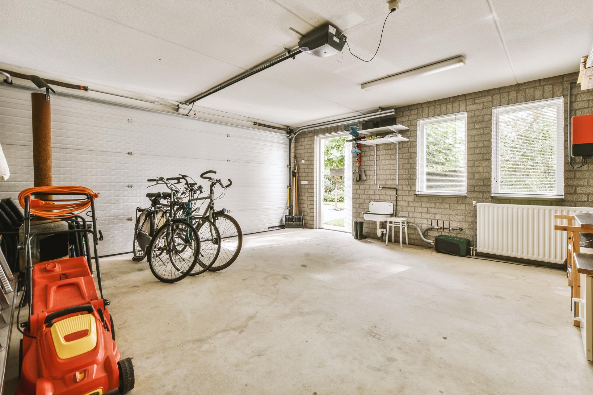 A garage with a bike and a car
