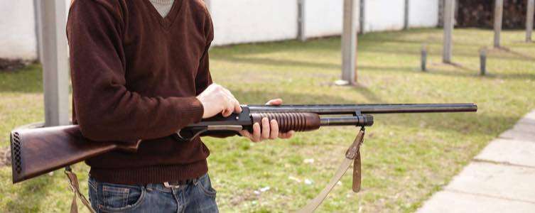 Man loading pump action shotgun